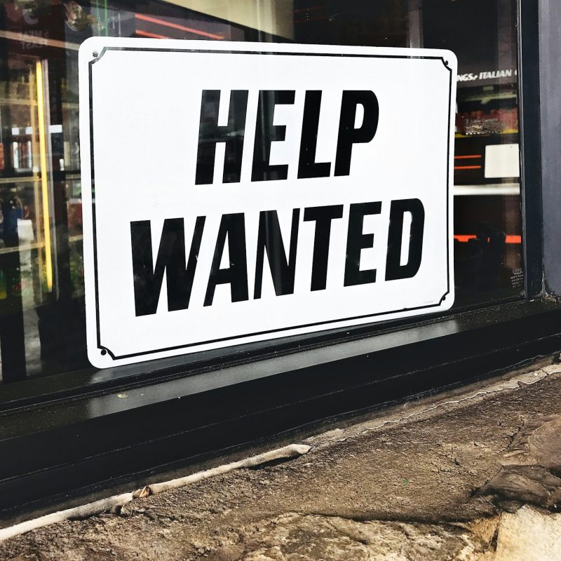 Business needs to hire new employees so they put out a help wanted sign